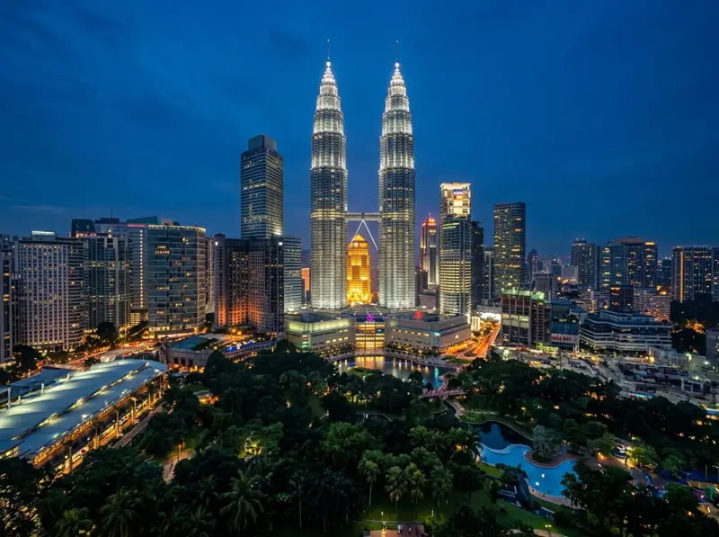 Petronas Twin Towers lit up against the evening sky in Kuala Lumpur
